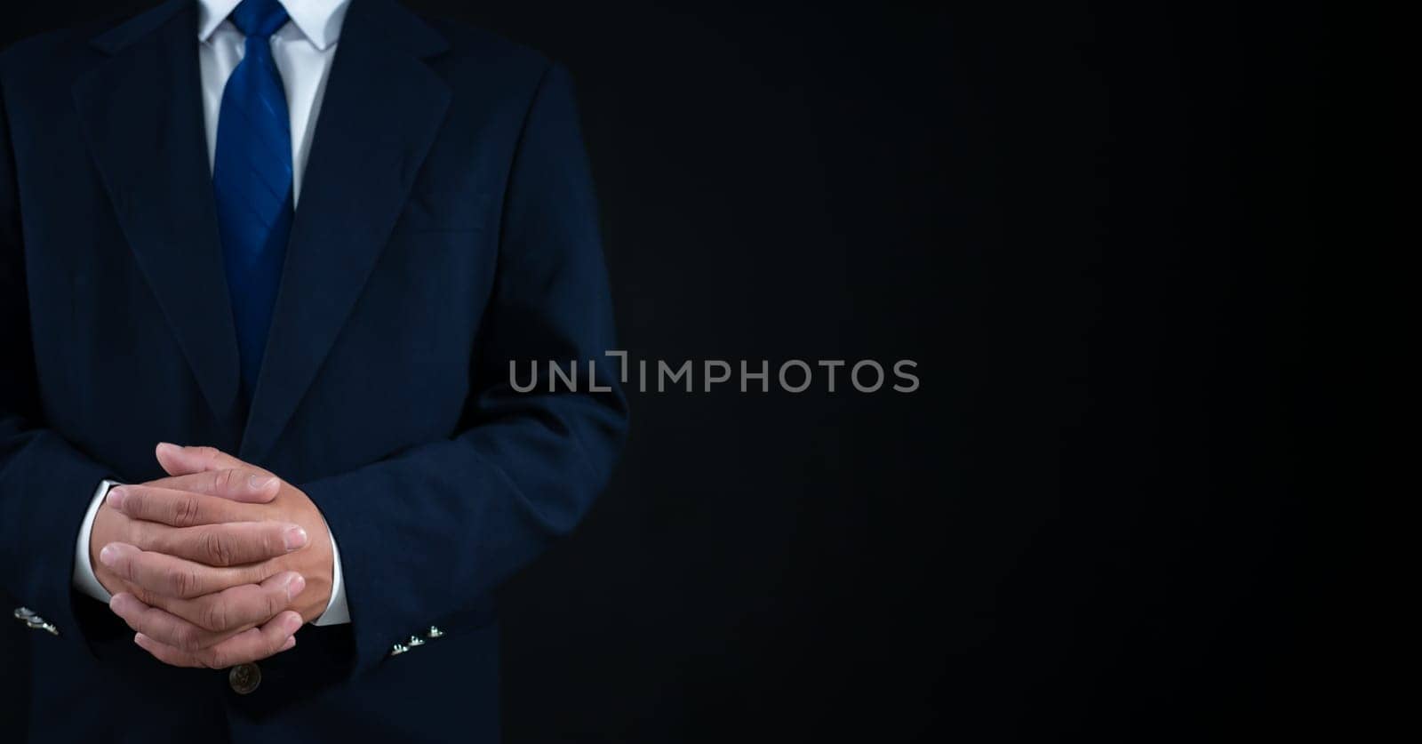 Businessman standing on dark gradient background. Business concept. Banner sign. by Unimages2527