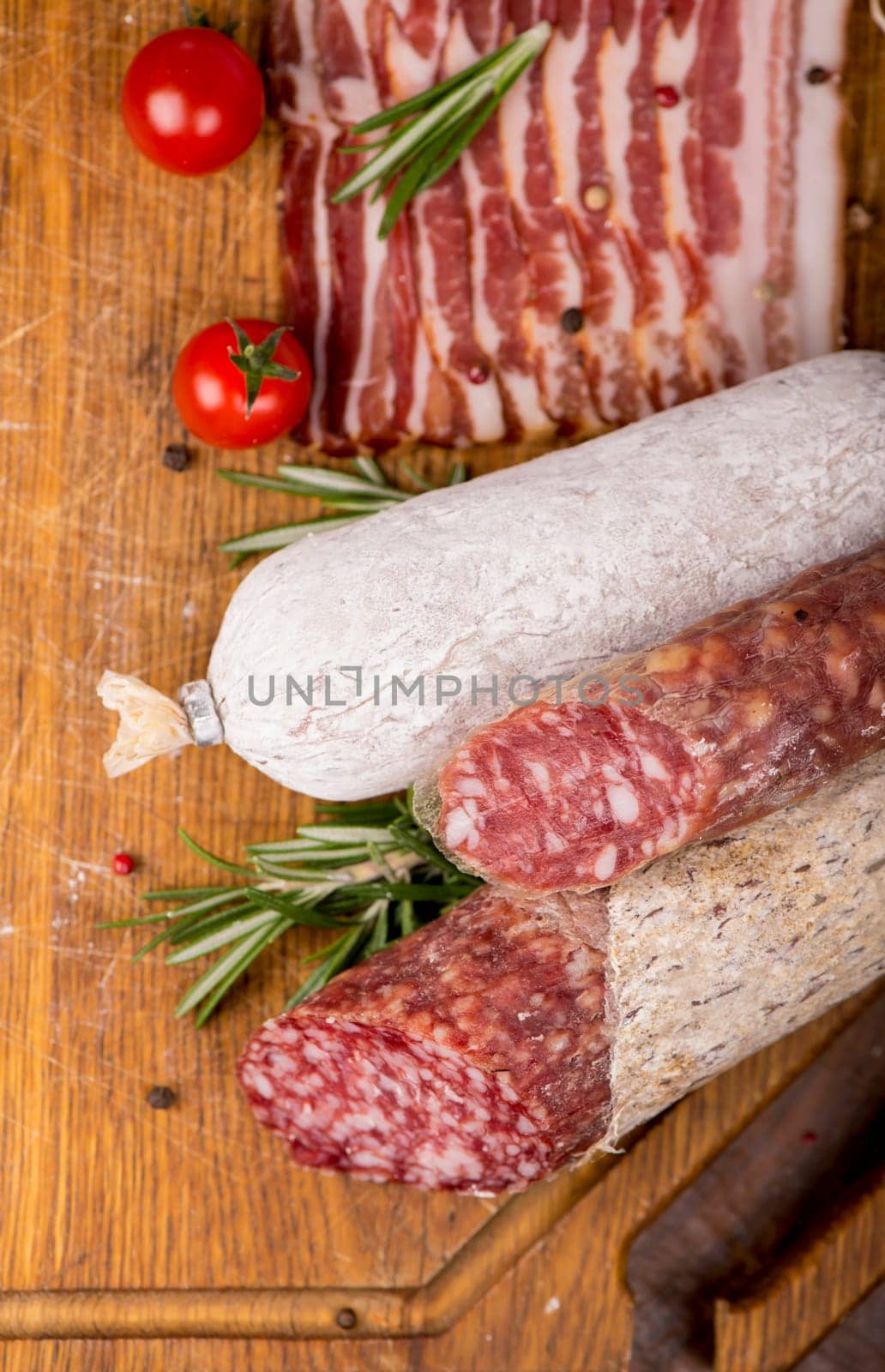 Various Smoked sausage with rosemary and peppercorns tomatoes and garlic by aprilphoto