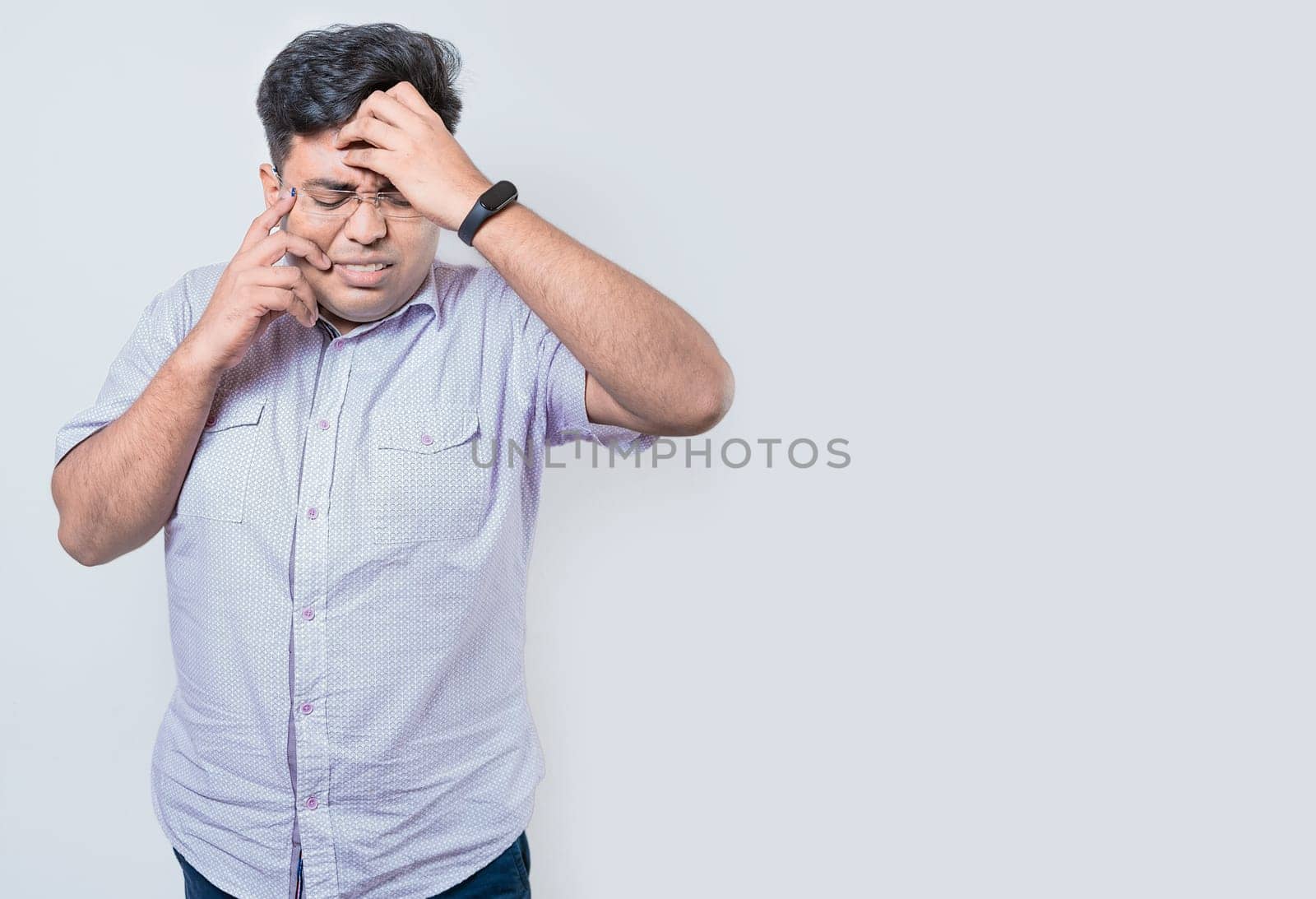 Exhausted person putting the palm of his hand on his face. Fatigued and exhausted man isolated. Concept of a bored and tired man