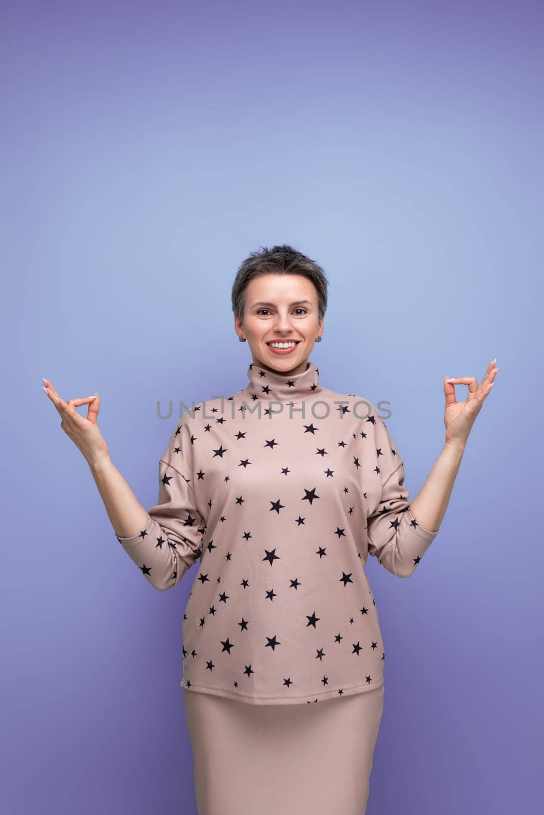 pretty caucasian young woman with short haircut dressed in a beige suit with a hollywood smile.