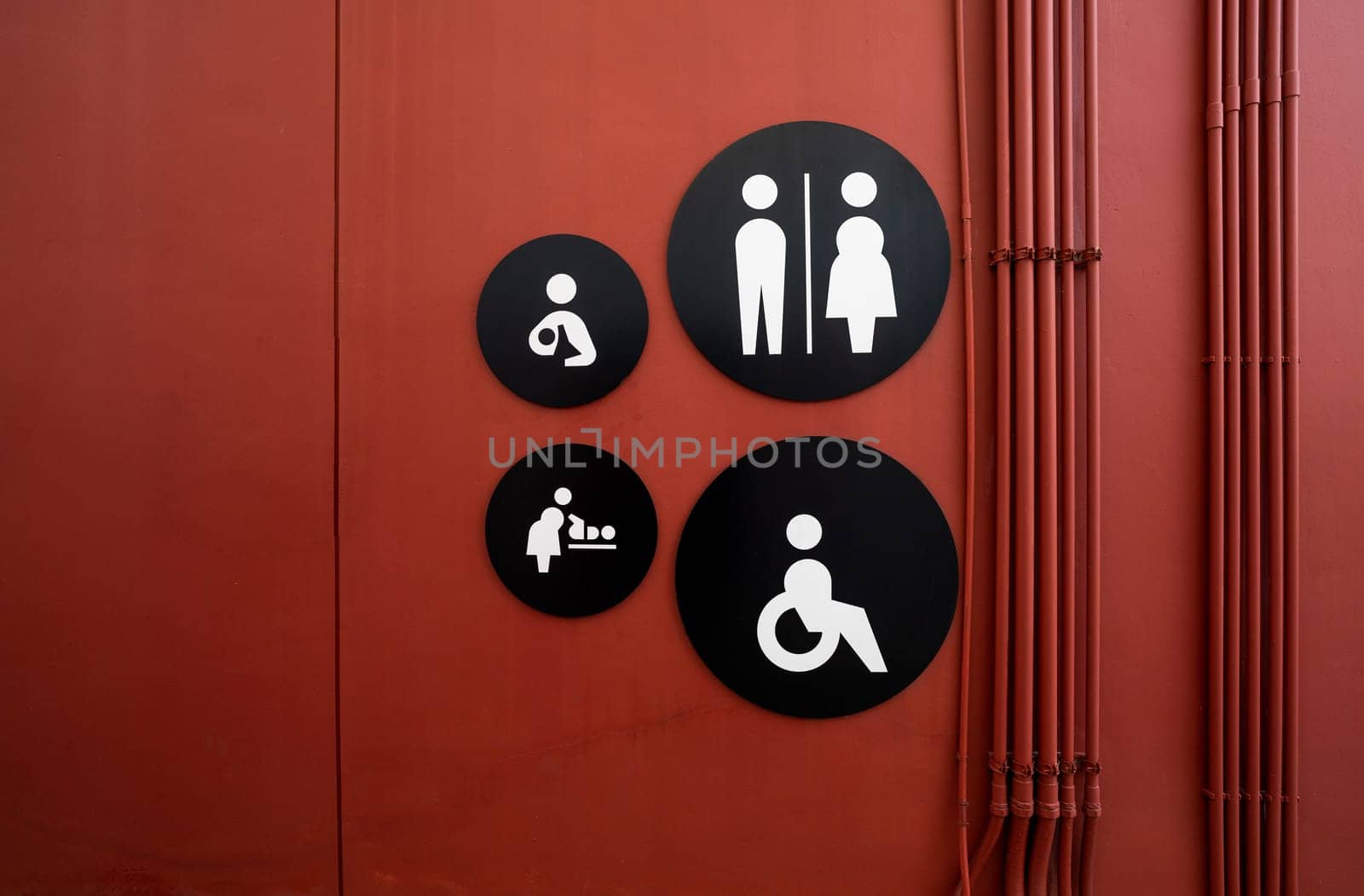 Public toilet sign. Woman, men, children, baby diaper changing, and disabled person toilet icon on restroom wall. Public restroom universal icon. Disabled access symbol. Latrine or WC. Washroom sign.