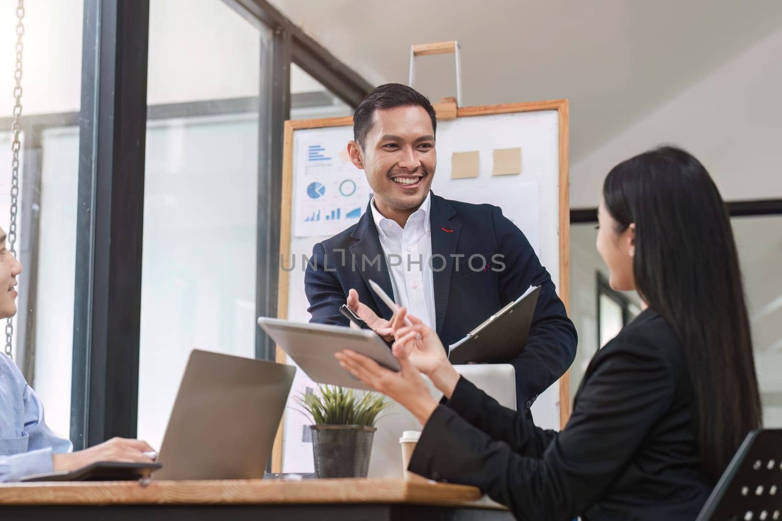 Close up of businesswoman presenting data analysis on board to her boss in company.