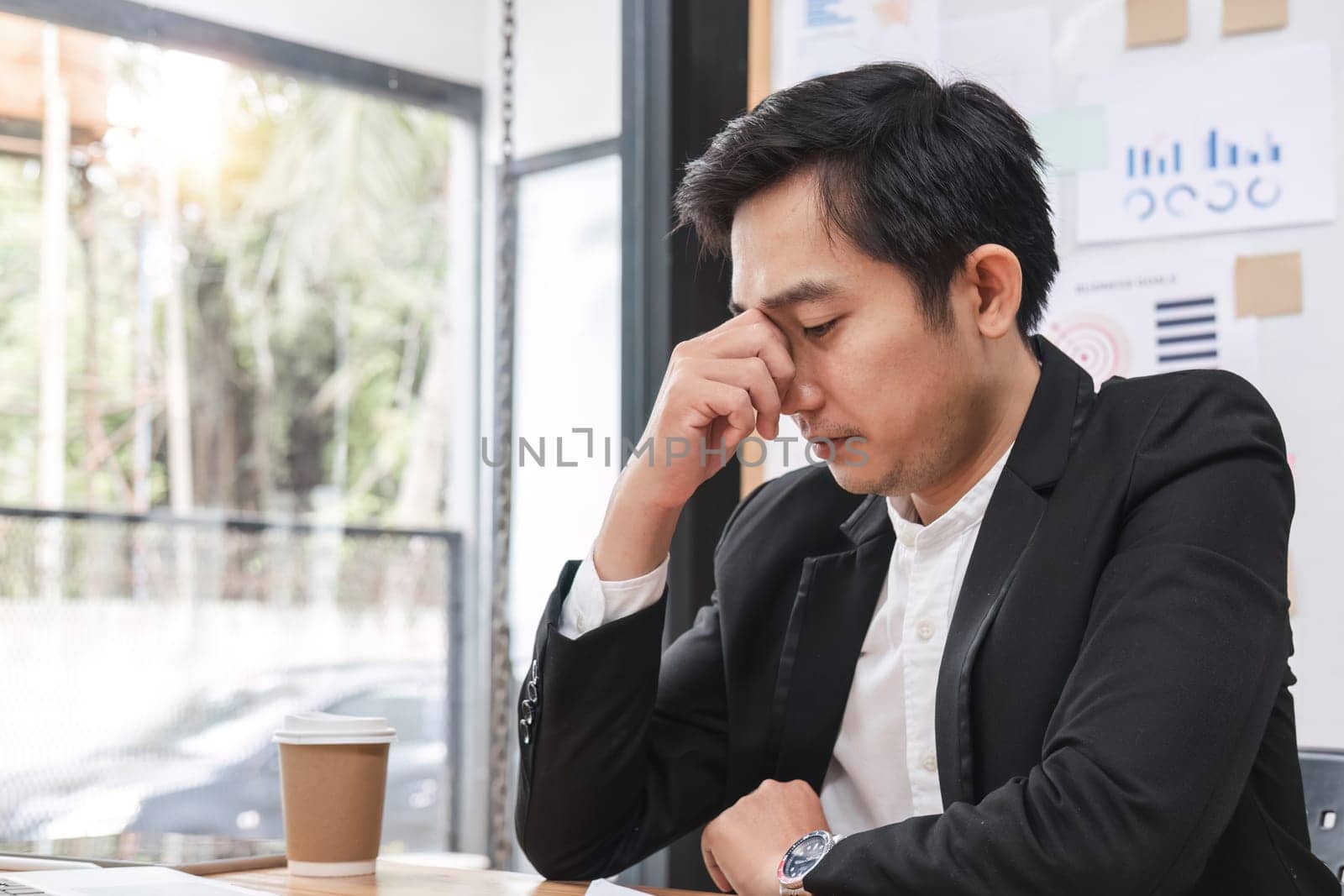 Businessman is tired and stressed from working in the office..