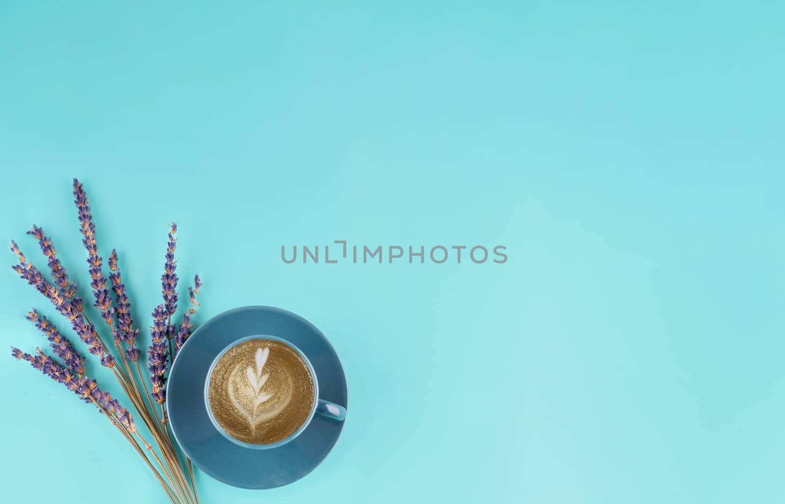 blue small cup of coffee and lavander on a blue background. Space for text by Iryna_Melnyk