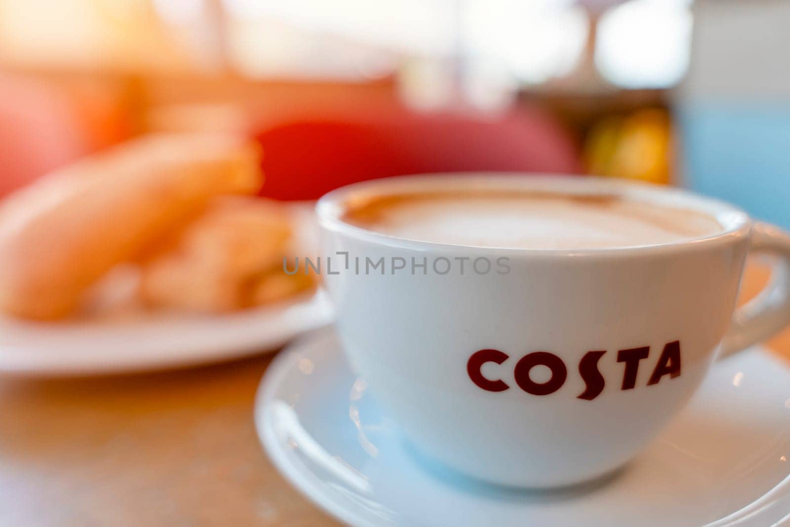 Sheffield, UK - June 02 2023  white cup of flat white coffee on a table in  COSTA cafe
