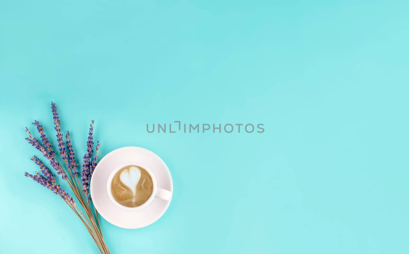 white small cup of coffee and lavander on a blue background. Space for text by Iryna_Melnyk