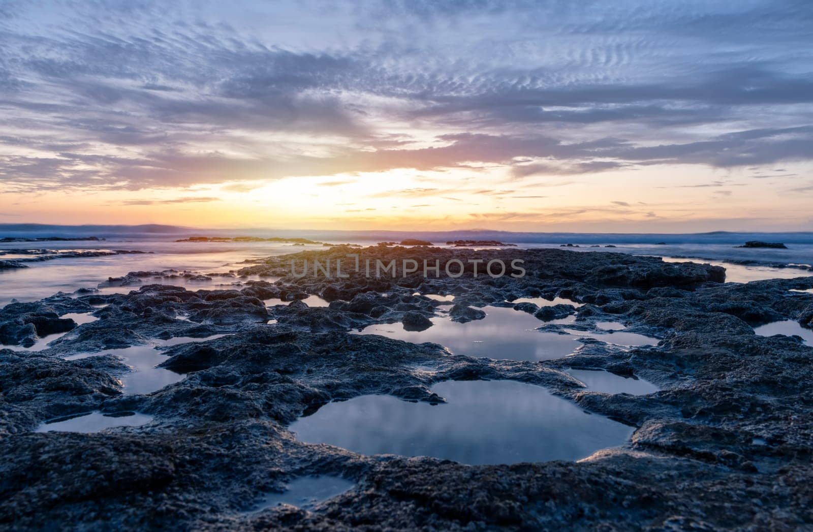 beautiful sunset  over the rocky coast in summer by Iryna_Melnyk