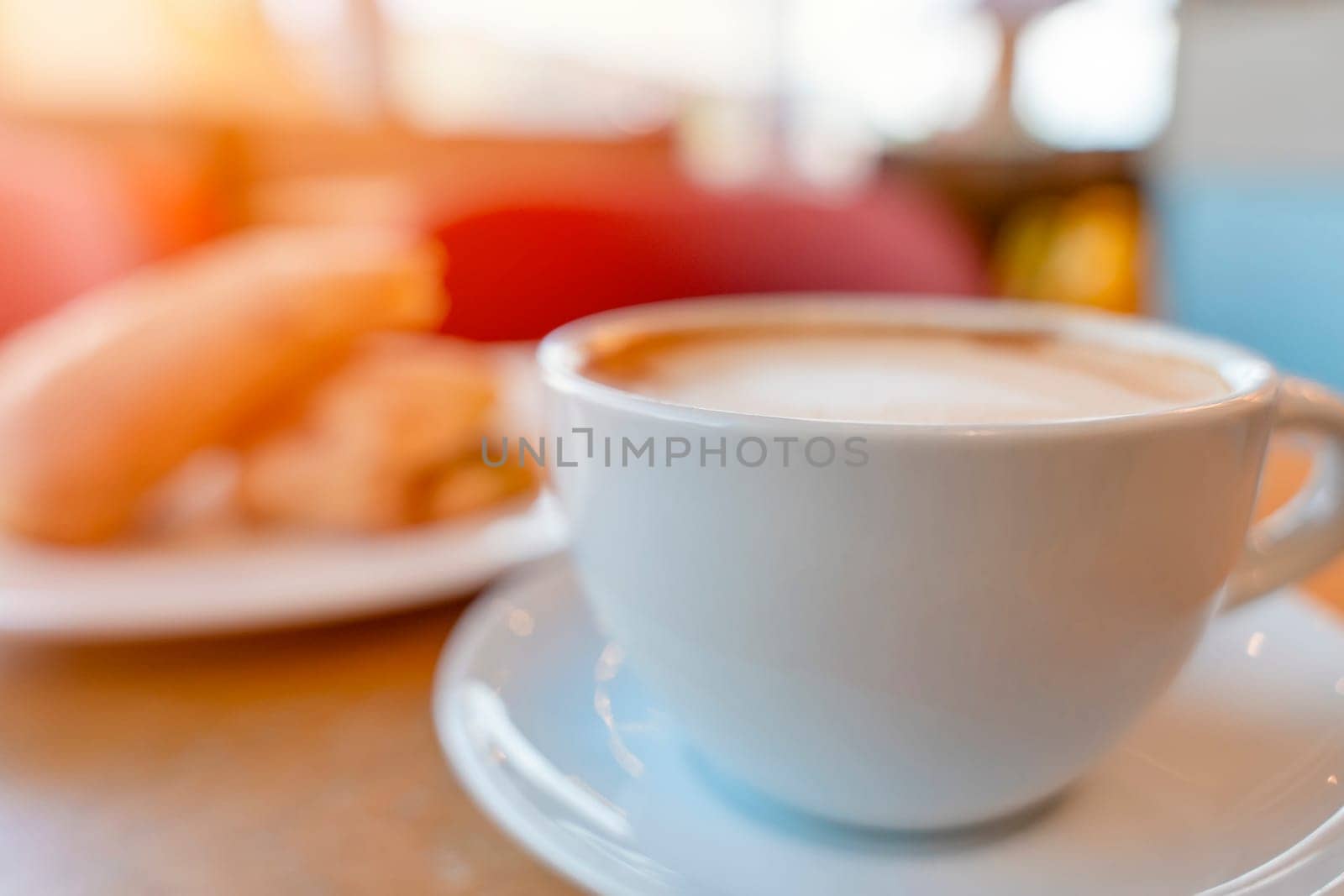 wide angle  of cup of coffee and croissant on the table in the cafe
