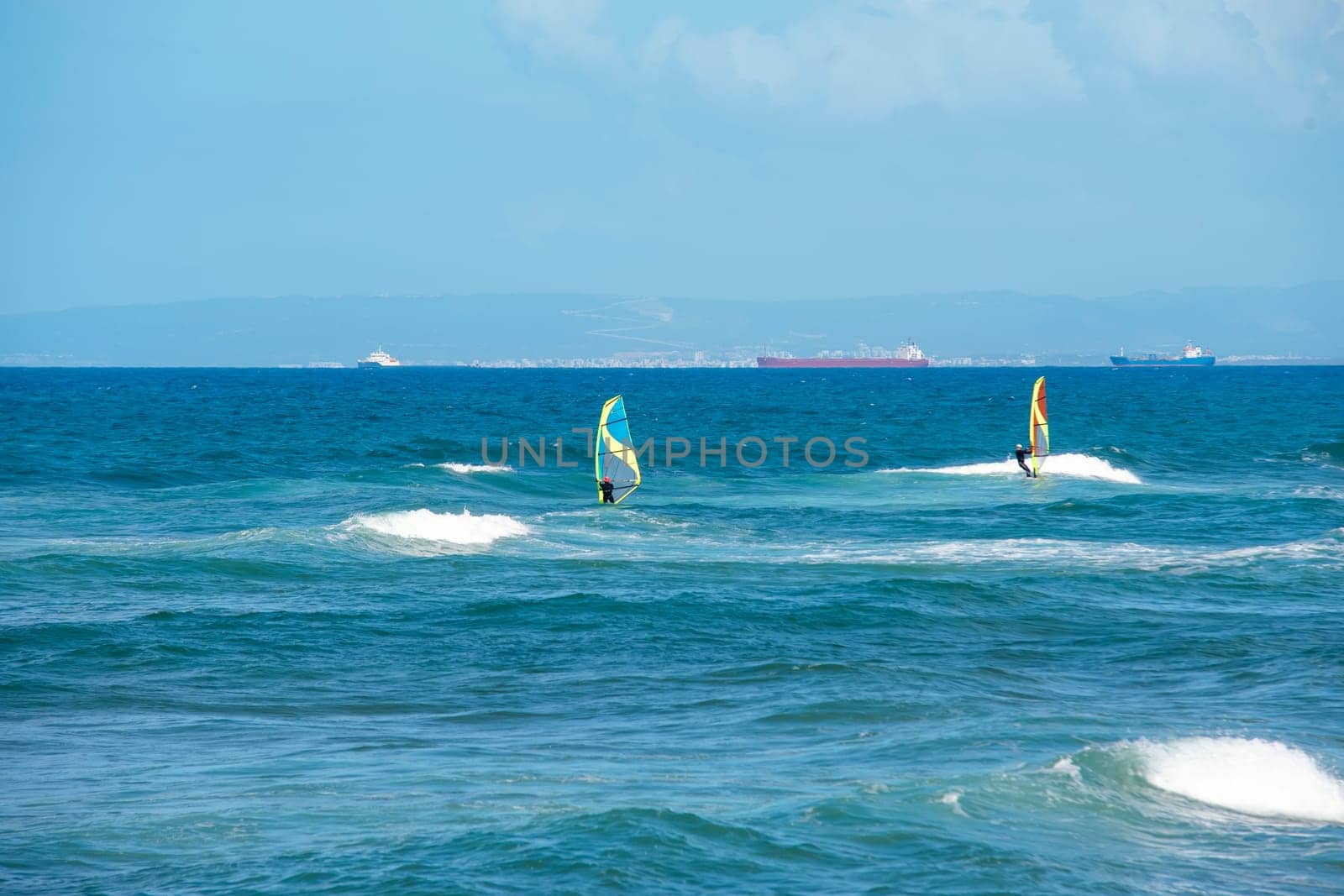 Enjoying extreme windsurfing and ocean waves on a hot sunny day. water sports concept