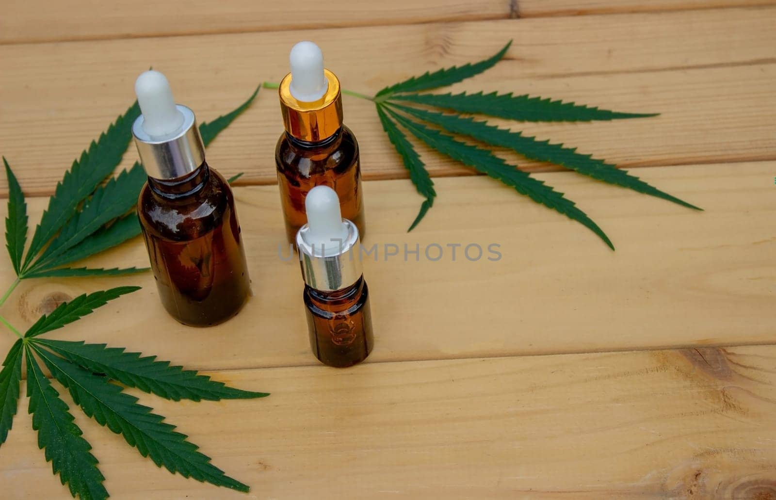 hemp essential oil on a wooden background, hemp leaves. Selective focus. Nature