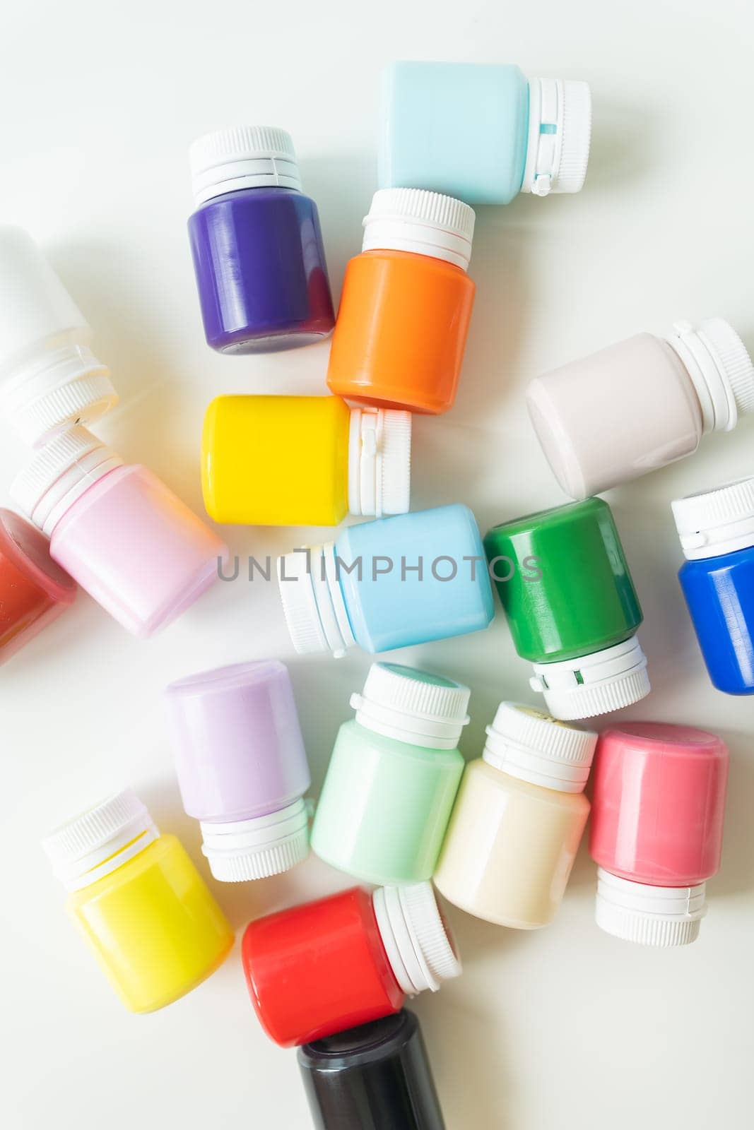 Banks of gouache, multi-colored acrylic paints isolated on white background