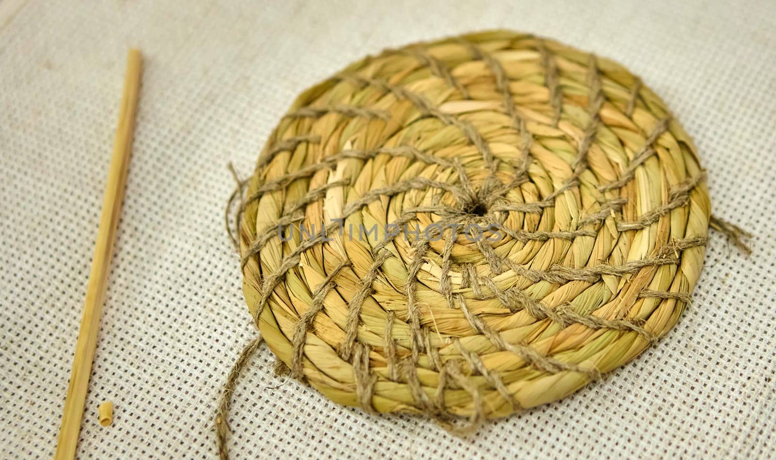 Close-up of Esparto round grass rug, natural fiber background. Weaving from grass and straw, handmade, circle.