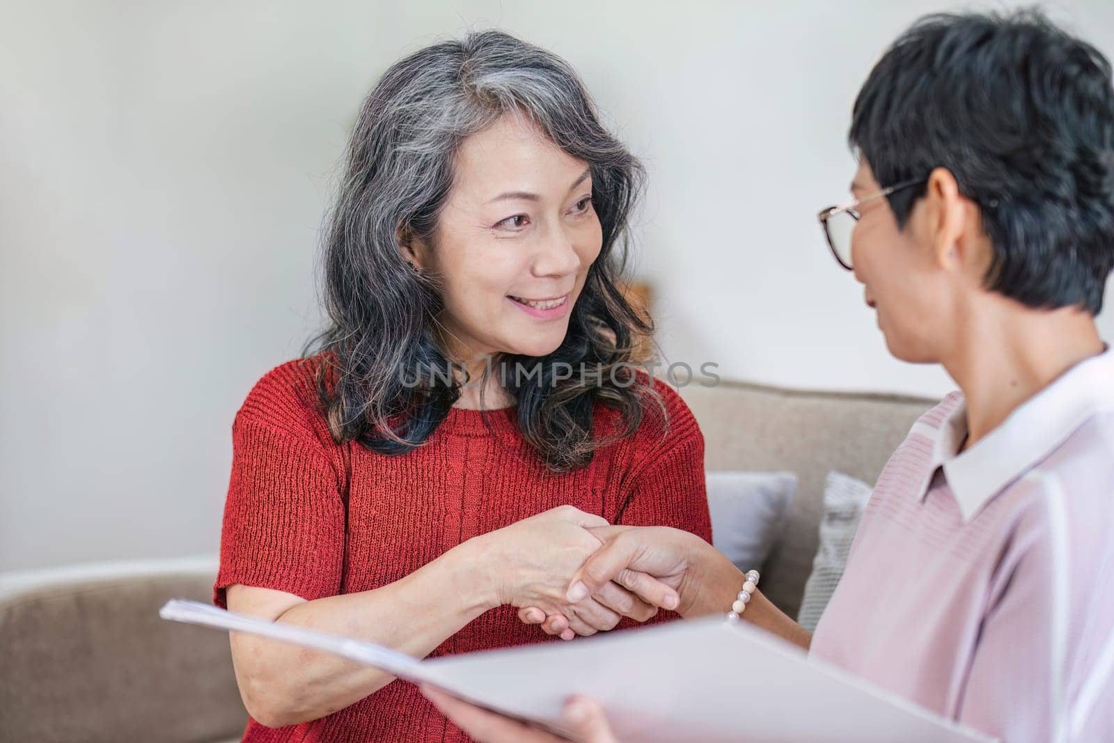 Senior woman planning future life insurance and finance happily in the living room..