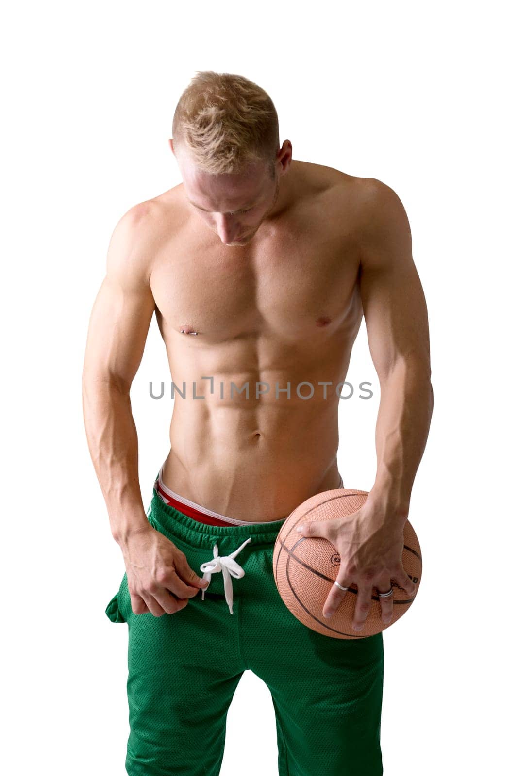 A man in green shorts holding a basketball