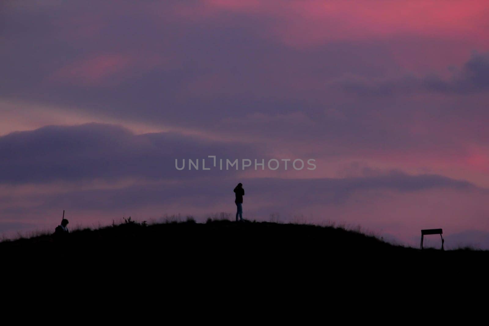 Silhouettes of people standing on the summit. by Puripatt
