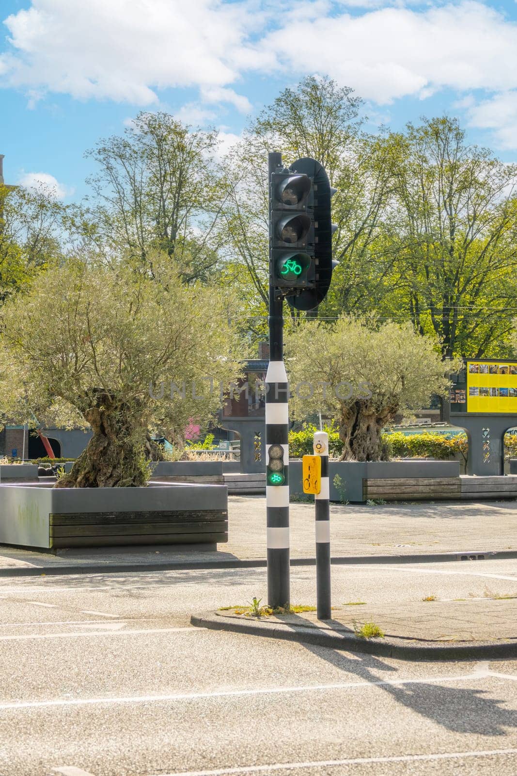 Netherlands. Sunny summer day in Amsterdam. Bicycle traffic light at the crossroads