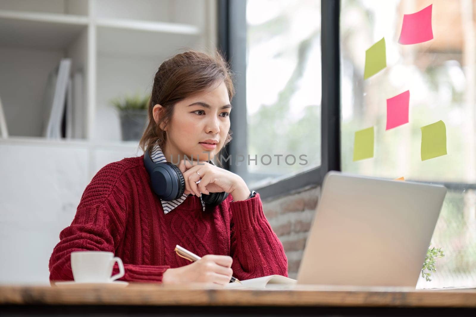 Asian female student study online in class, study online, wearing headphones, watching video call, zooming, happy asian female learning language online with computer laptop