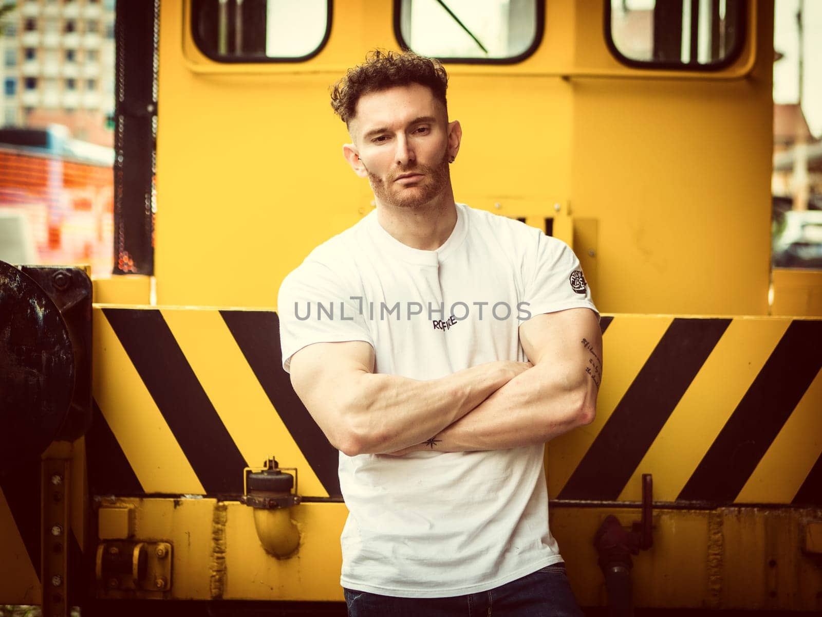 A man standing in front of a yellow train