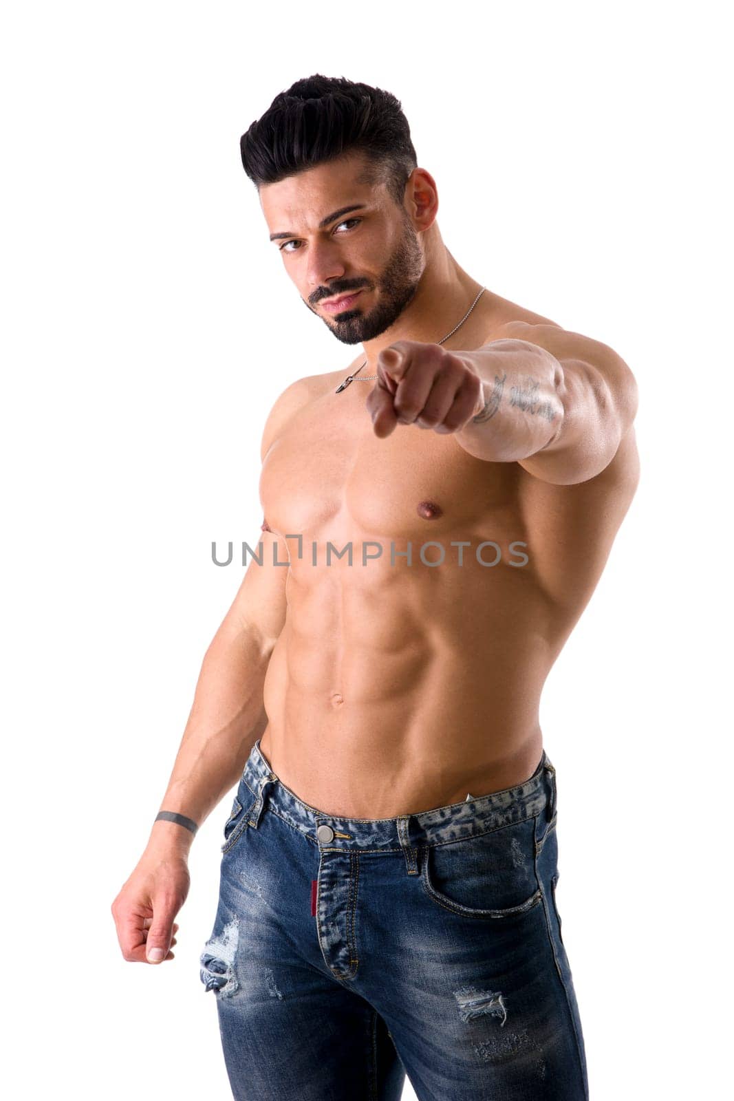 A shirtless man pointing at the camera