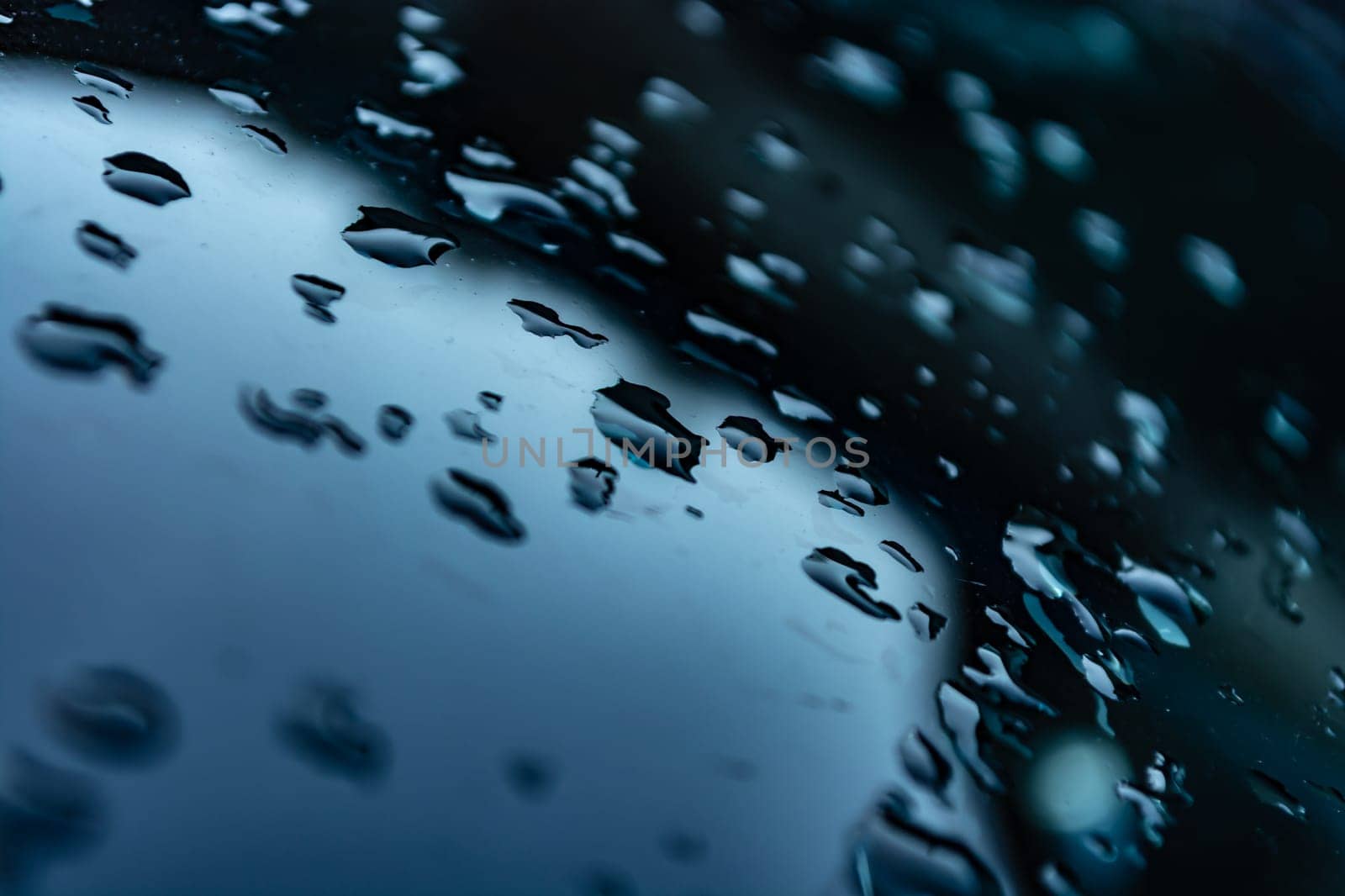 Drops of rain water close-up on the glass of a car. Background. Backdrop. Selective focus.