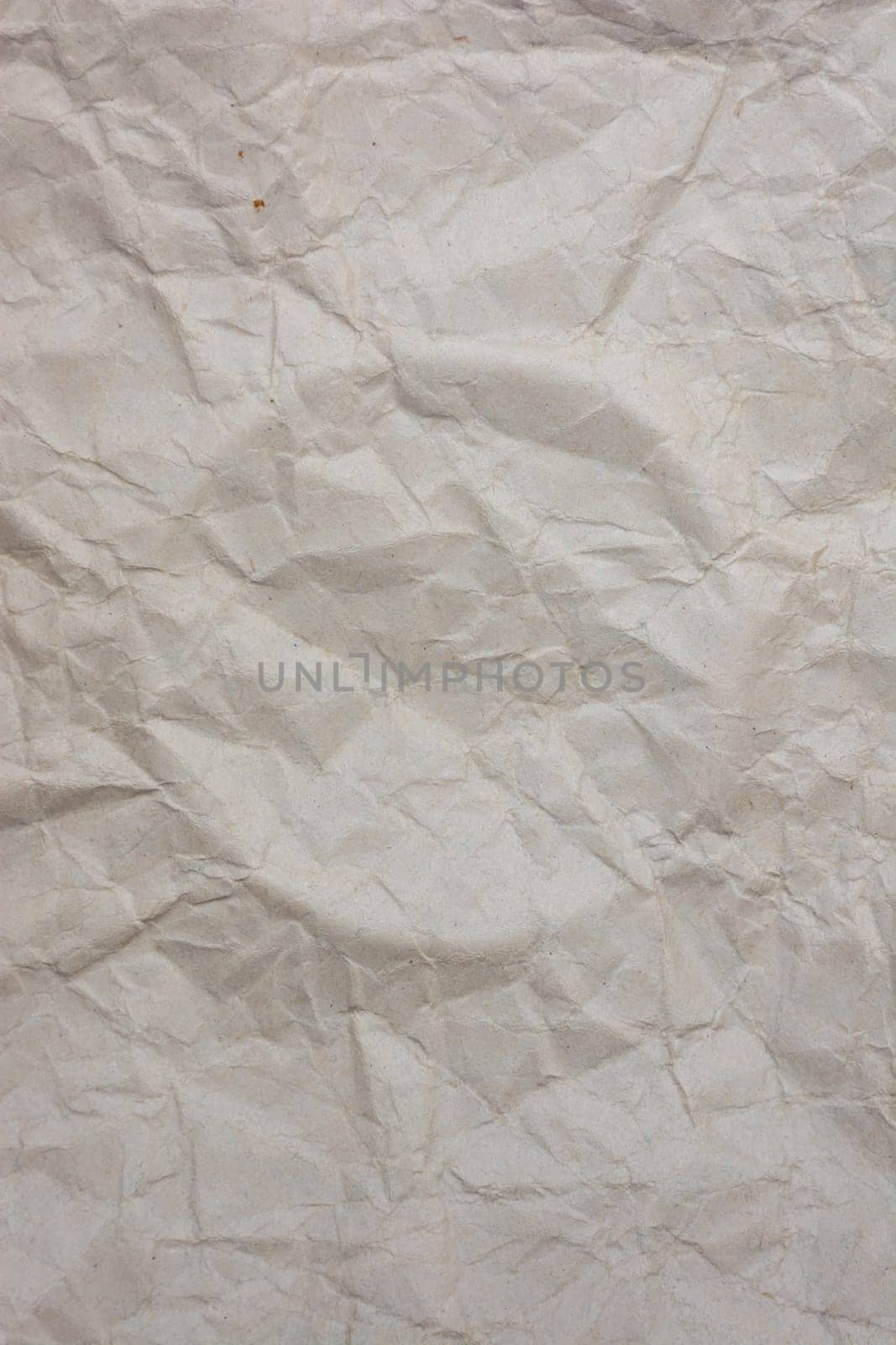 Vertical background from old crumpled paper, a circle is squeezed out in the middle. Backdrop