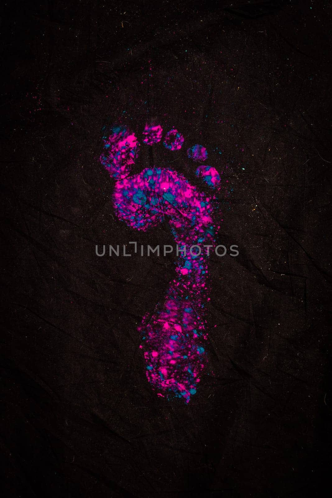 Photo of a colorful footprint on a dark background by artofphoto