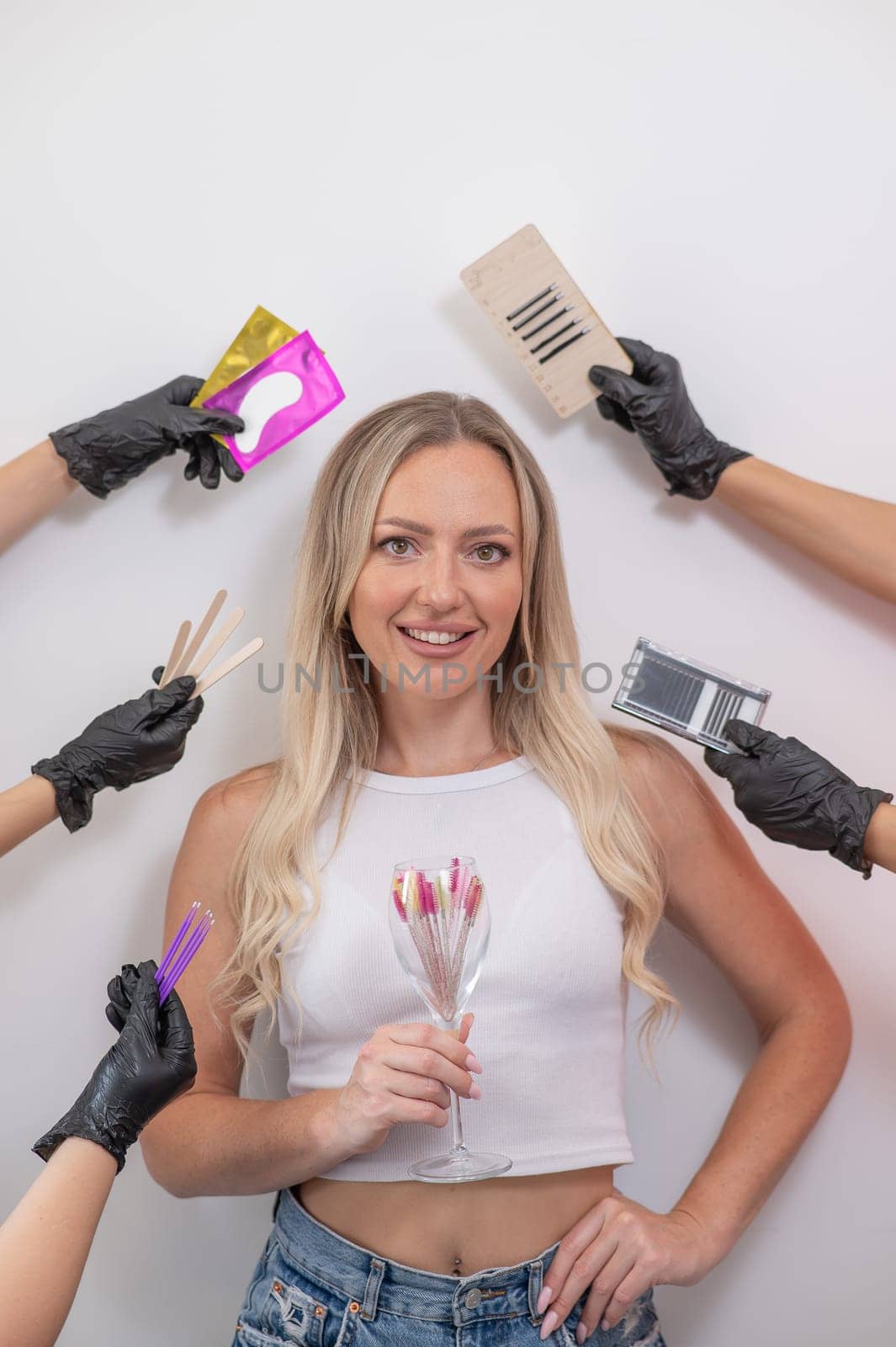 Portrait of caucasian woman and masters hands with eyelash extension tools. by mrwed54