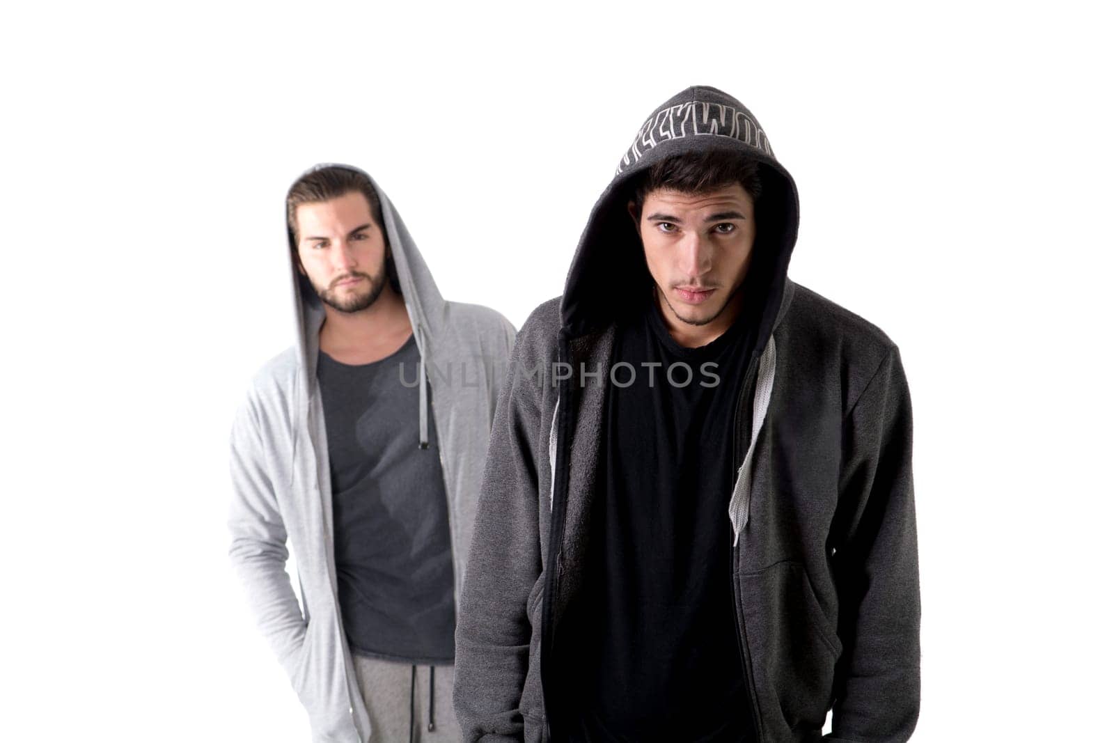 Two seemingly dangerous thugs standing next to each other in front of a white background