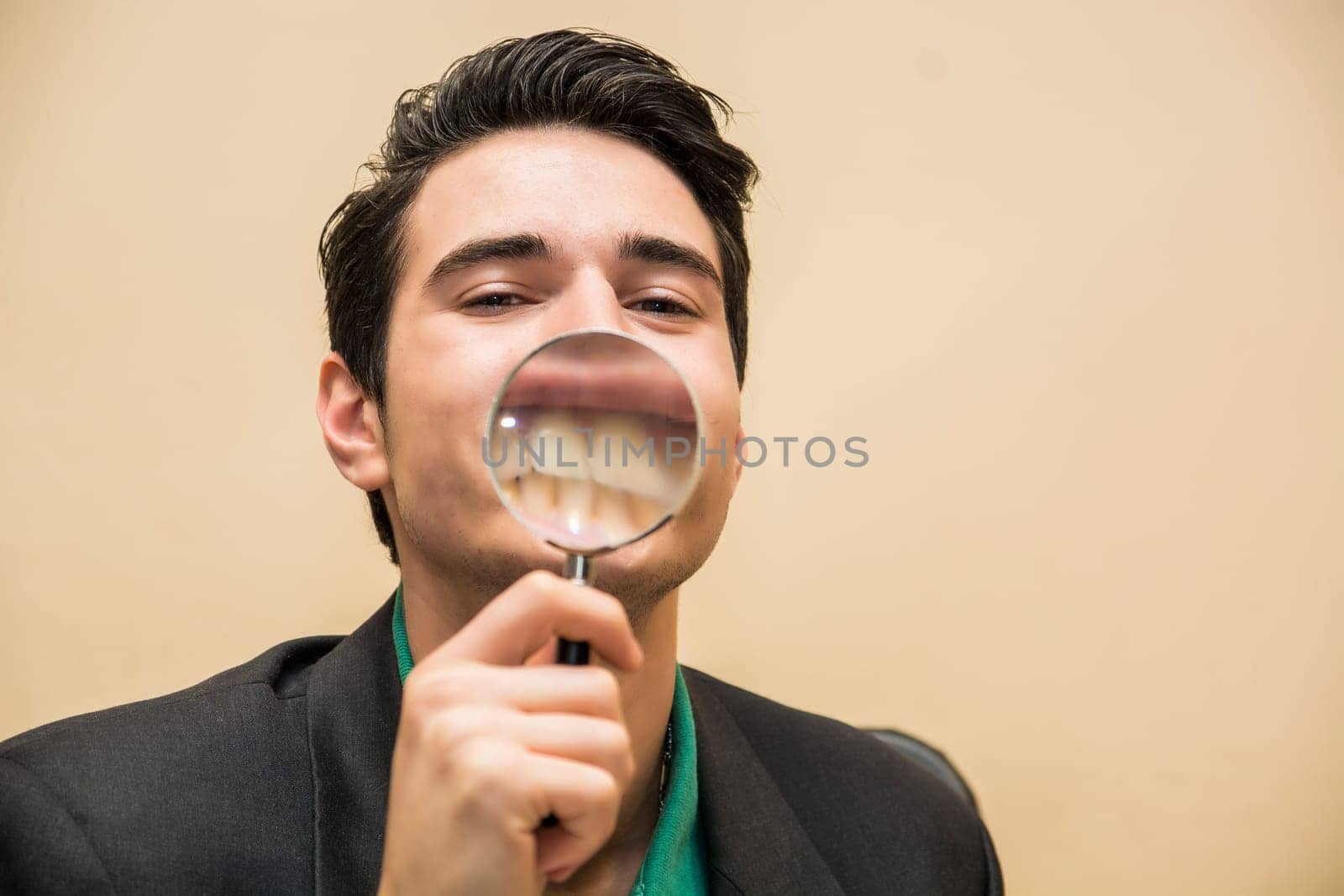 Photo of a man examining something closely with a magnifying glass by artofphoto