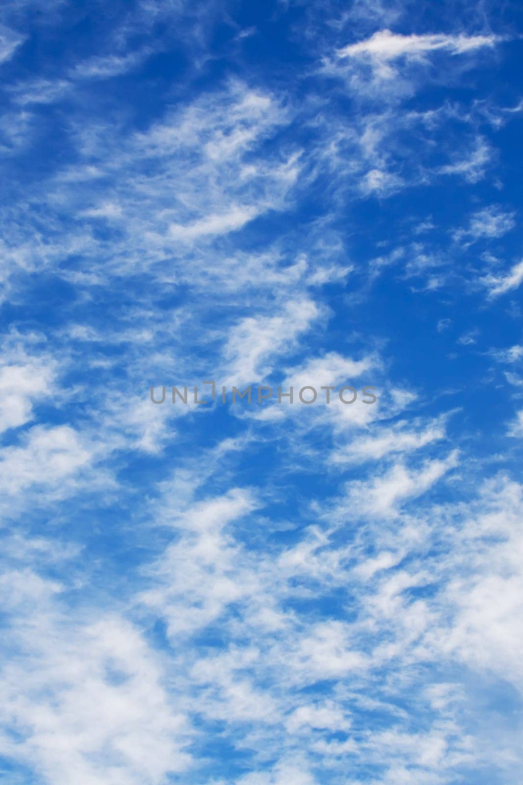 White clouds in bright blue sky close up