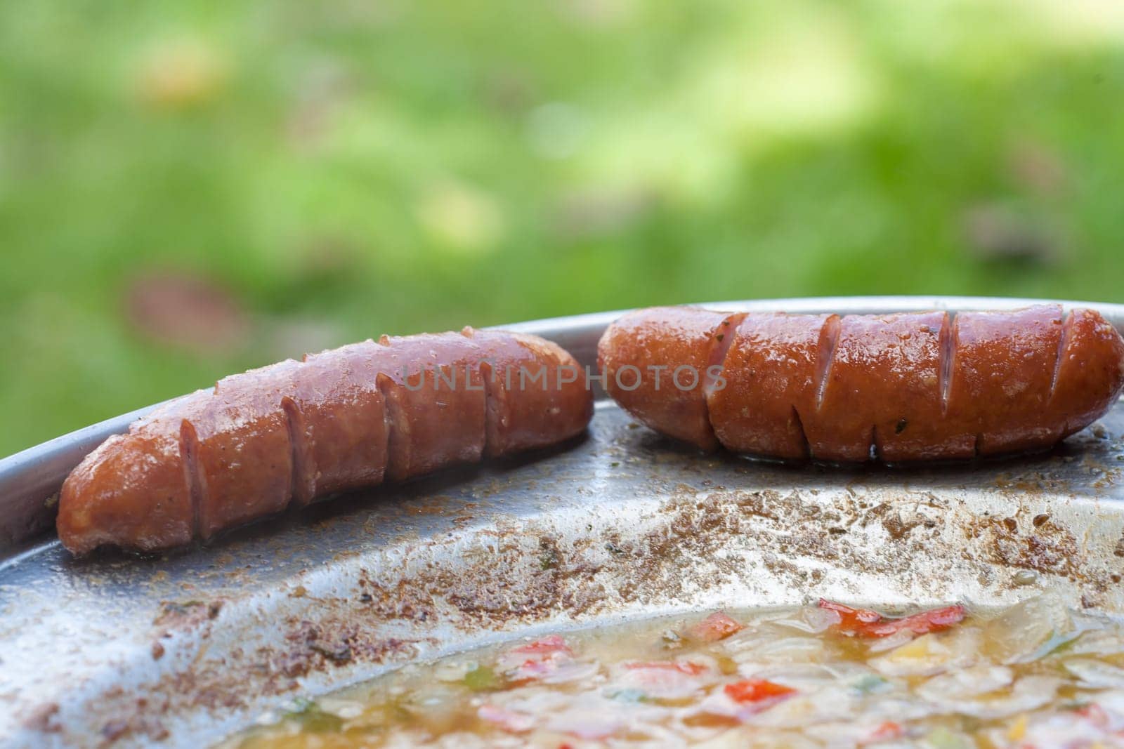 Baked sausages in traditional croatian dish kotlovina