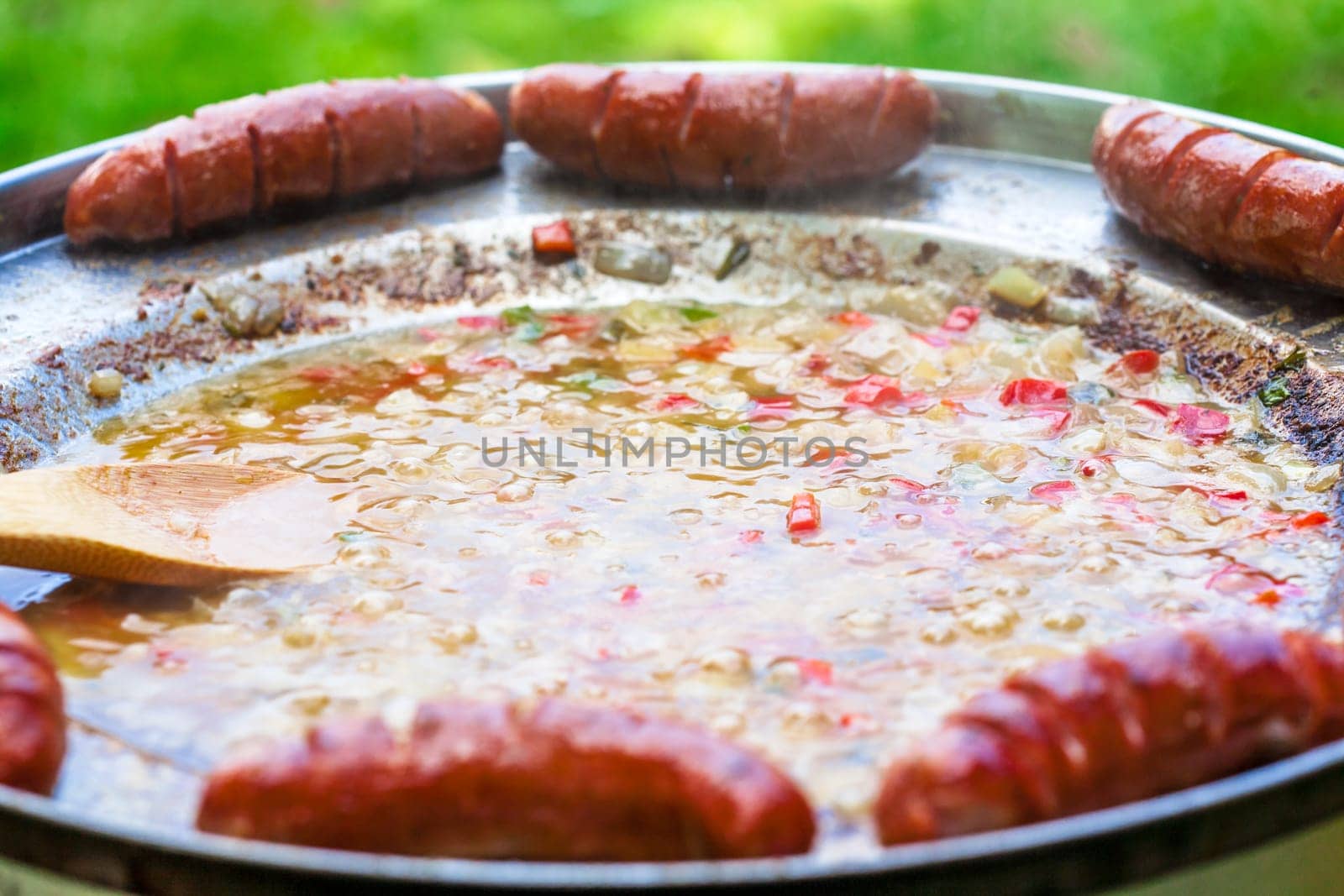 Baked sausages in traditional Croatian dish kotlovina.