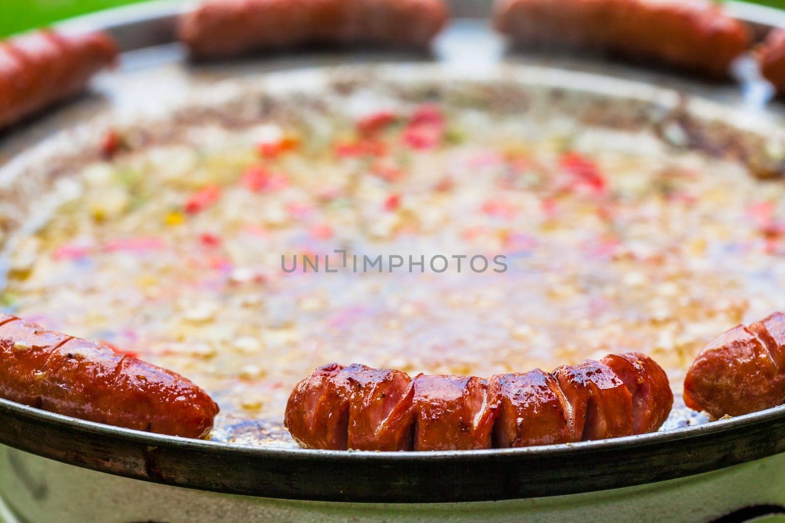 Baked sausages in traditional Croatian dish kotlovina.