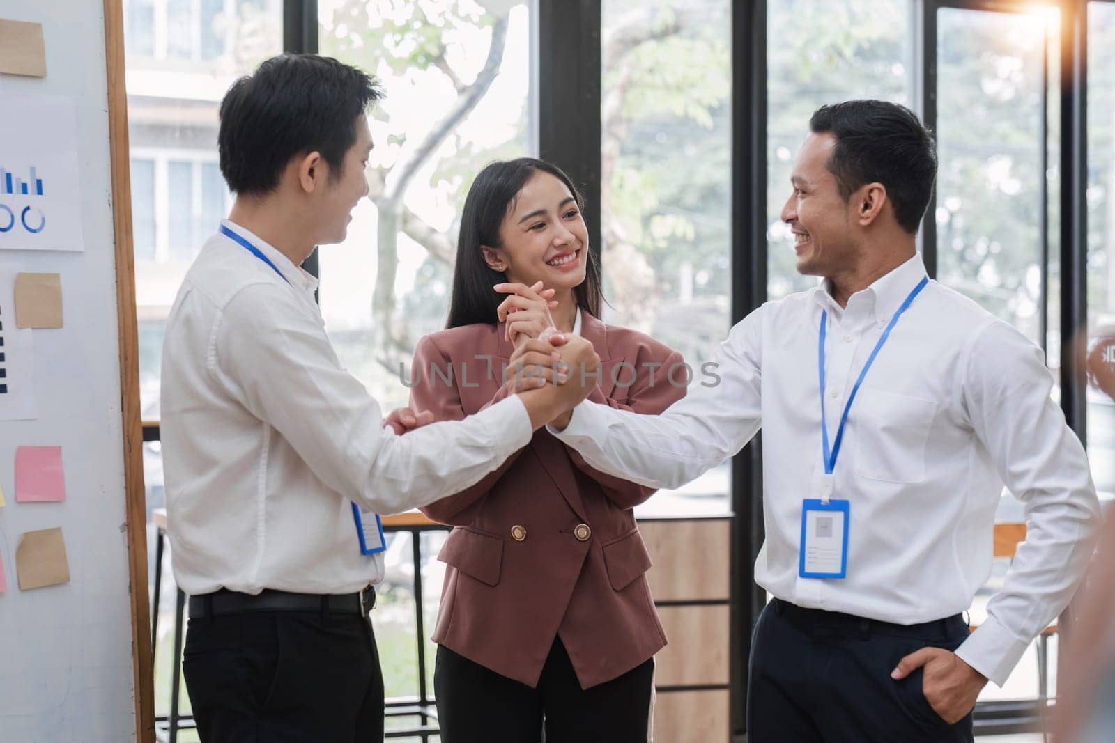 Professional businessmen shake hands to congratulate after business success. by wichayada