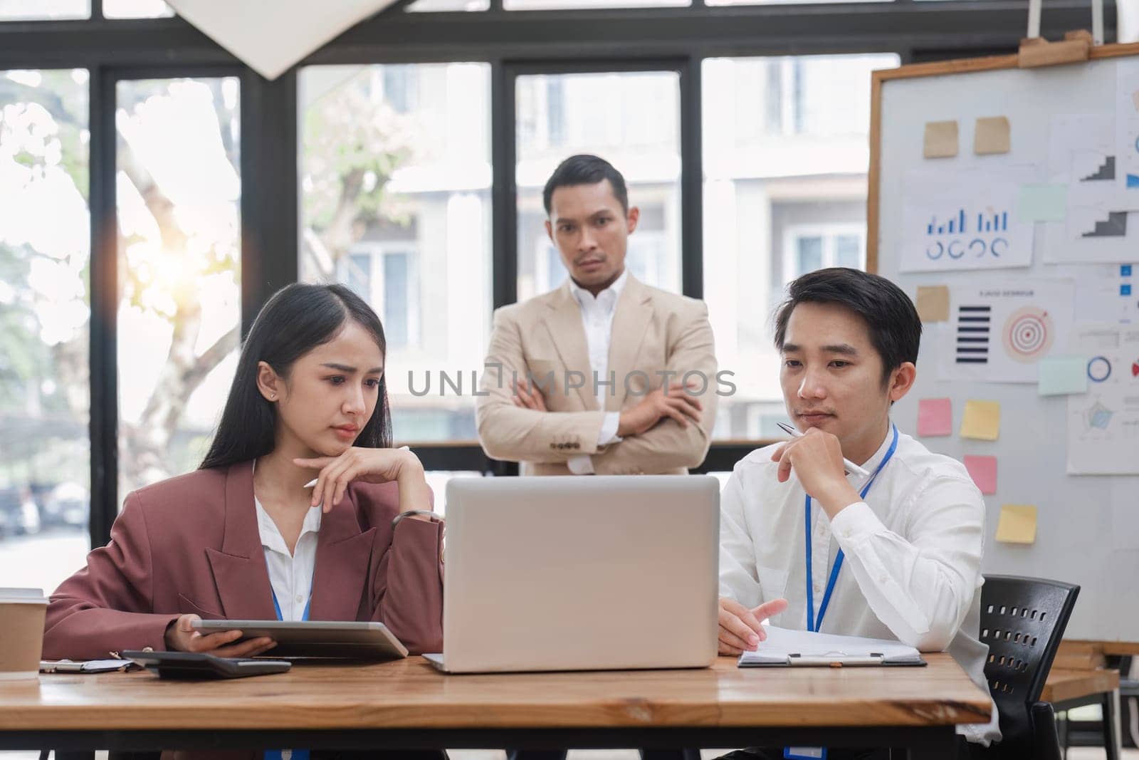 Group of business people working together and solving the problem of working stress in the meeting room at the office. by wichayada