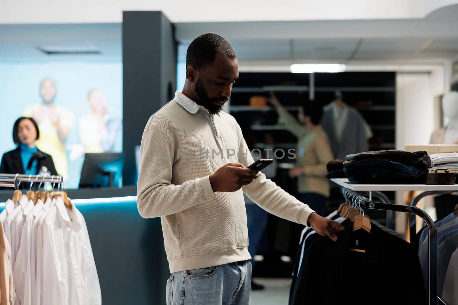 Man scrolling app while shopping in mall by DCStudio