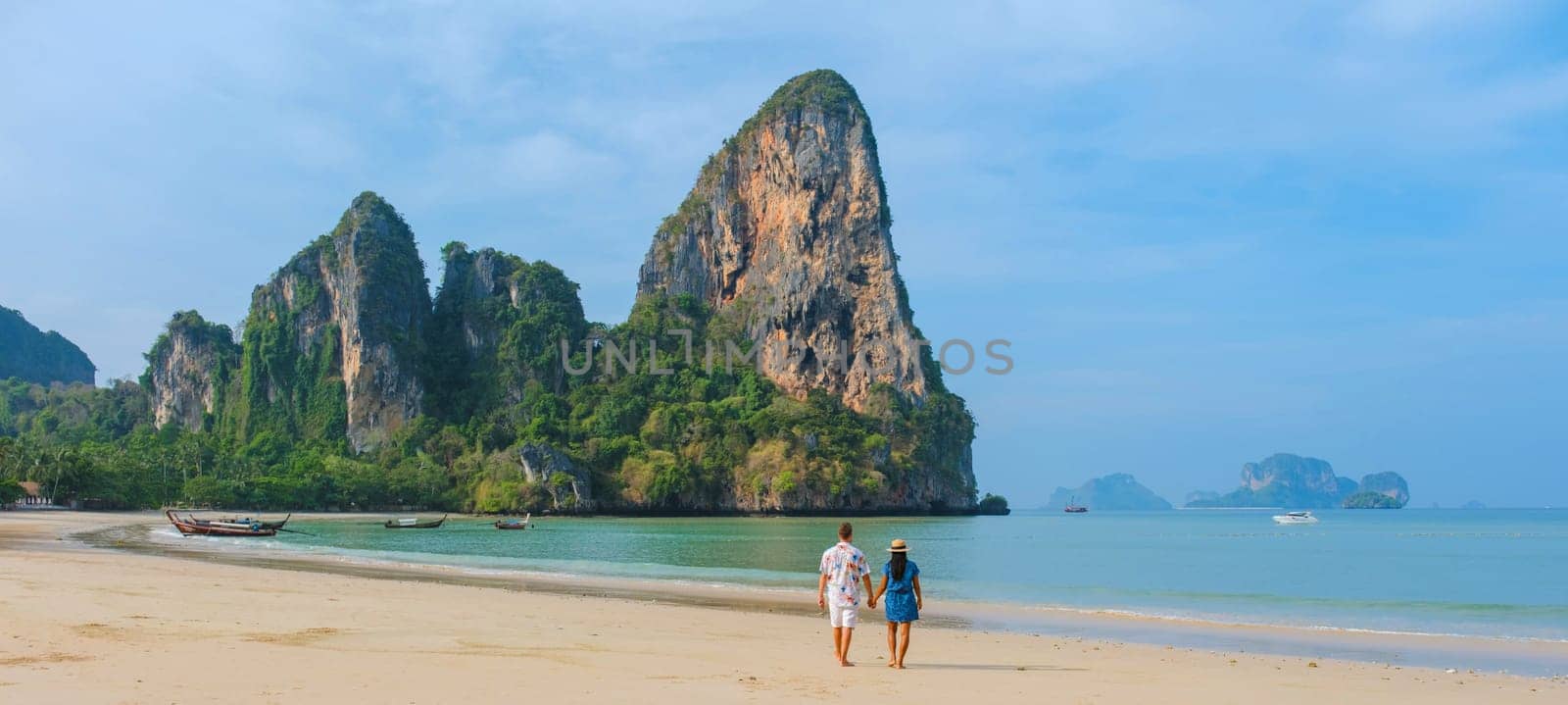 Railay beach Krabi Thailand, tropical beach of Railay Krabi, couple men and woman on the beach by fokkebok