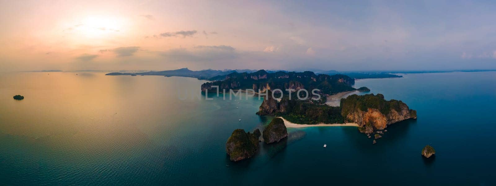 Railay Beach Krabi Thailand, the tropical beach of Railay Krabi, view from a drone of idyllic Railay Beach in Thailand in the evening at sunset with a cloudy sky. Panorama of Railay Beach