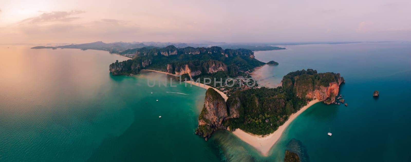 Railay Beach Krabi Thailand, the tropical beach of Railay Krabi, view from a drone of idyllic Railay Beach in Thailand in the evening at sunset with a cloudy sky. Panorama of Railay Beach