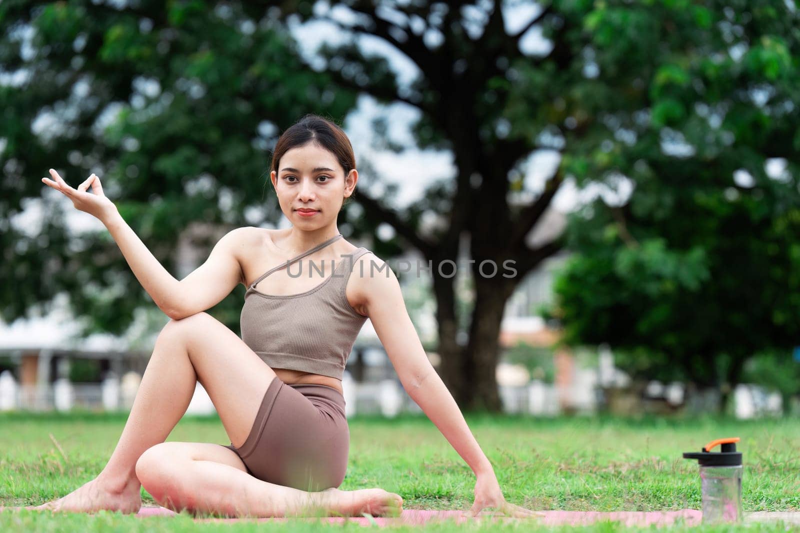 Asian woman wearing sportwear doing Yoga exercise in the nature.