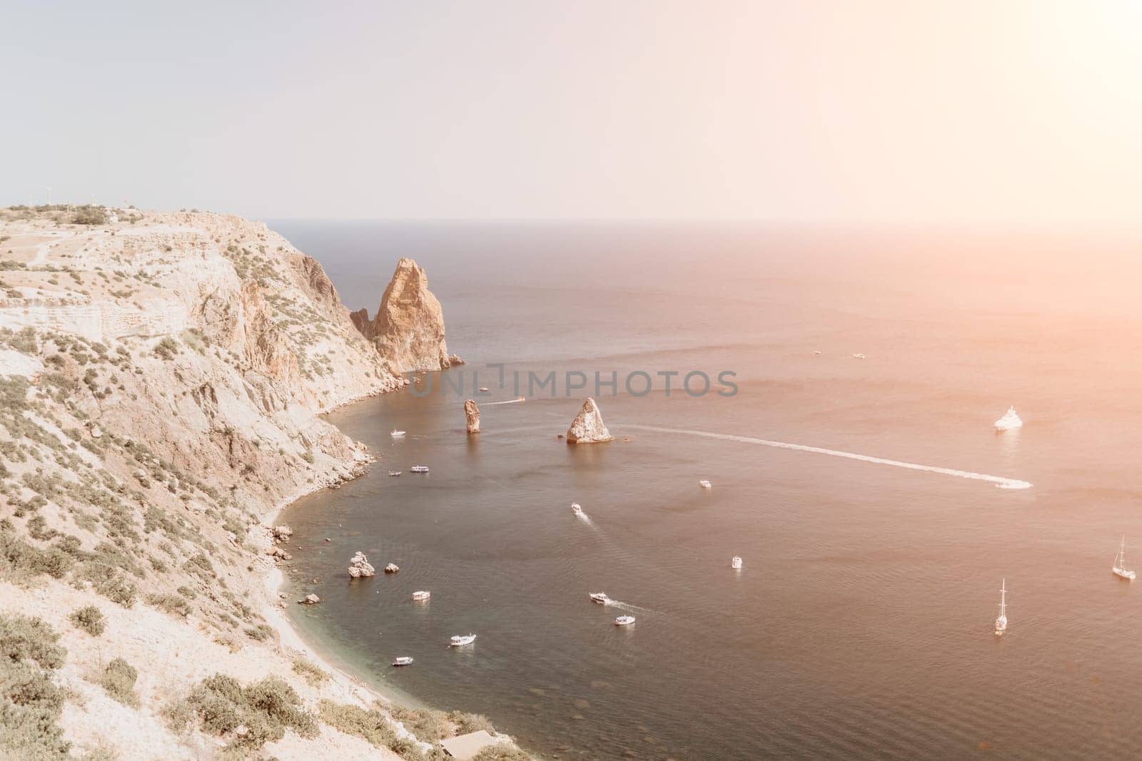 Aerial panoramic view of beautiful sunset above sea. Beautiful seascape. Sun glare, small waves on the water surface. Evening. Horizon. Nobody. No people. Copy space. Never-ending beauty of nature
