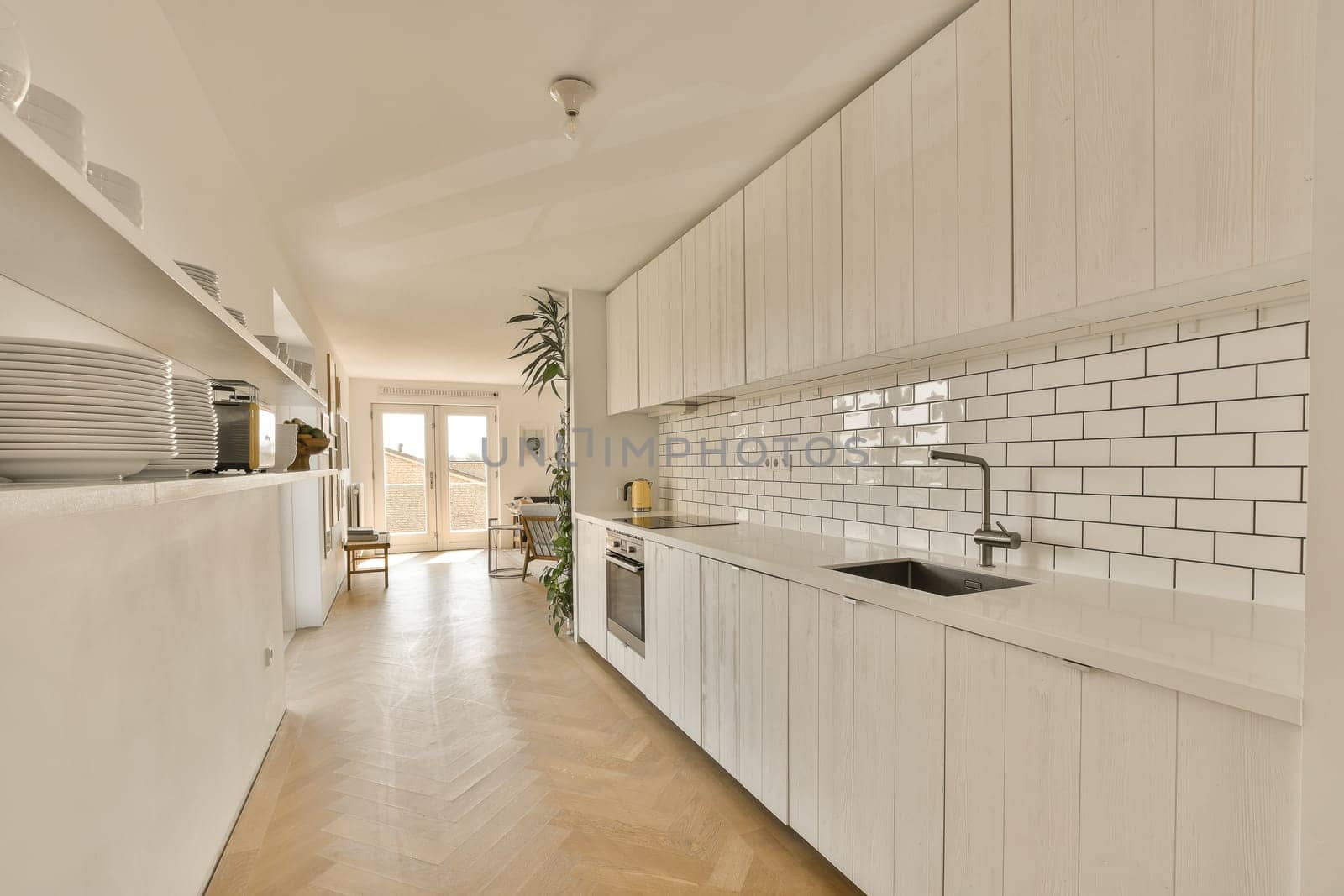 a large white kitchen with white cabinets and a sink by casamedia