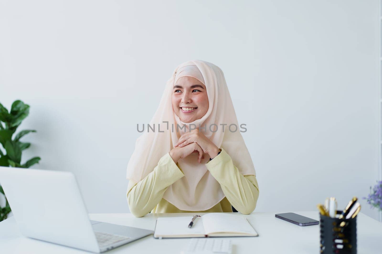 Muslim women use calculators, computers, and laptops to check their accounts at work. by Manastrong