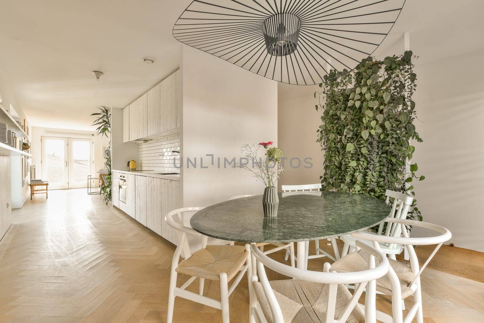 a dining table and chairs in a kitchen with an umbrella over the table that is hanging on the wall above it