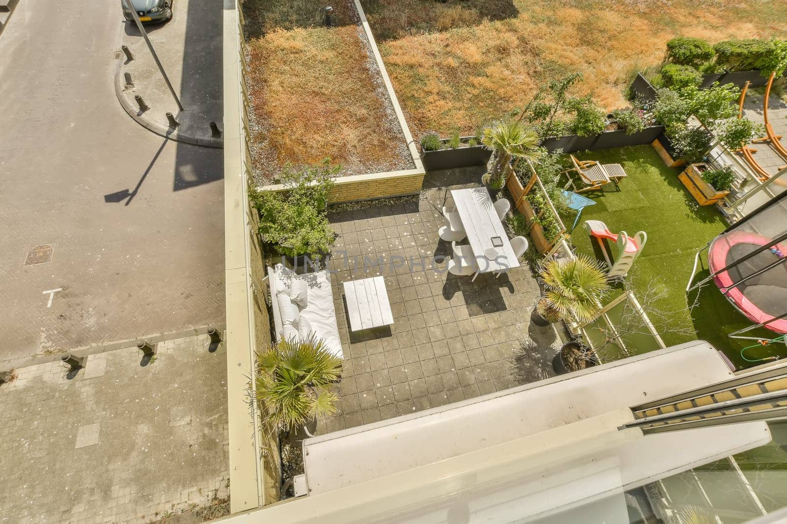 an aerial view from the roof of a house with a car parked on the street in front of the house