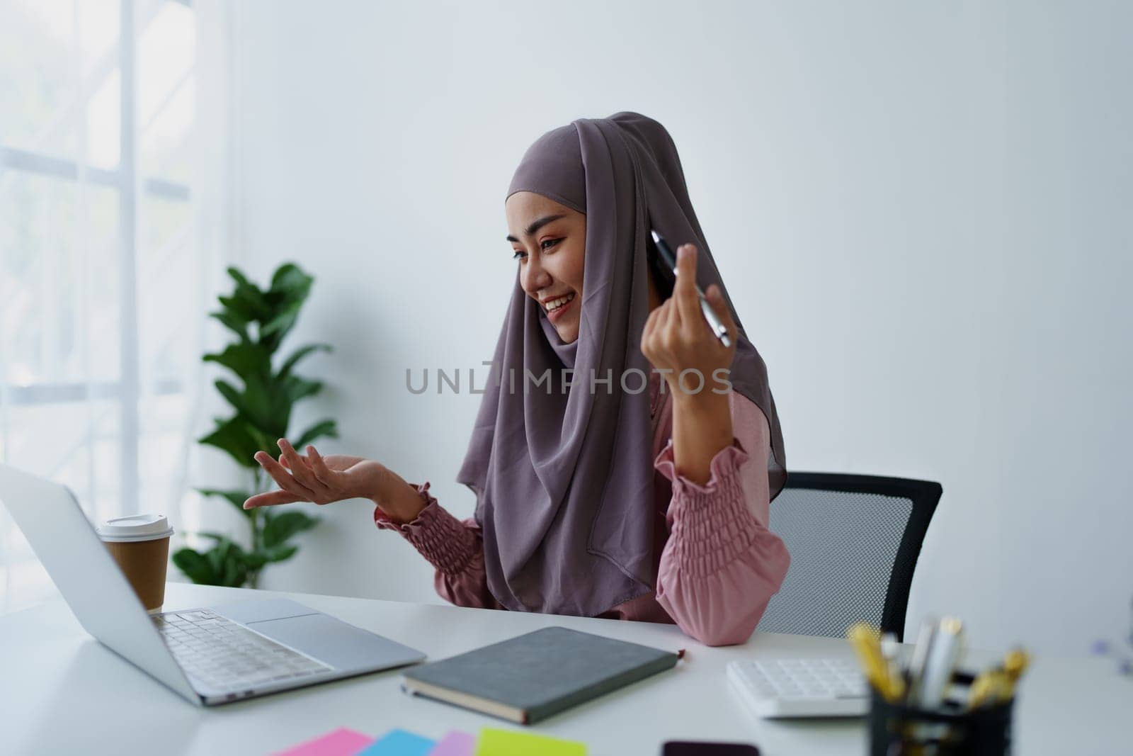 Muslim female employee Conferencing via computer during work