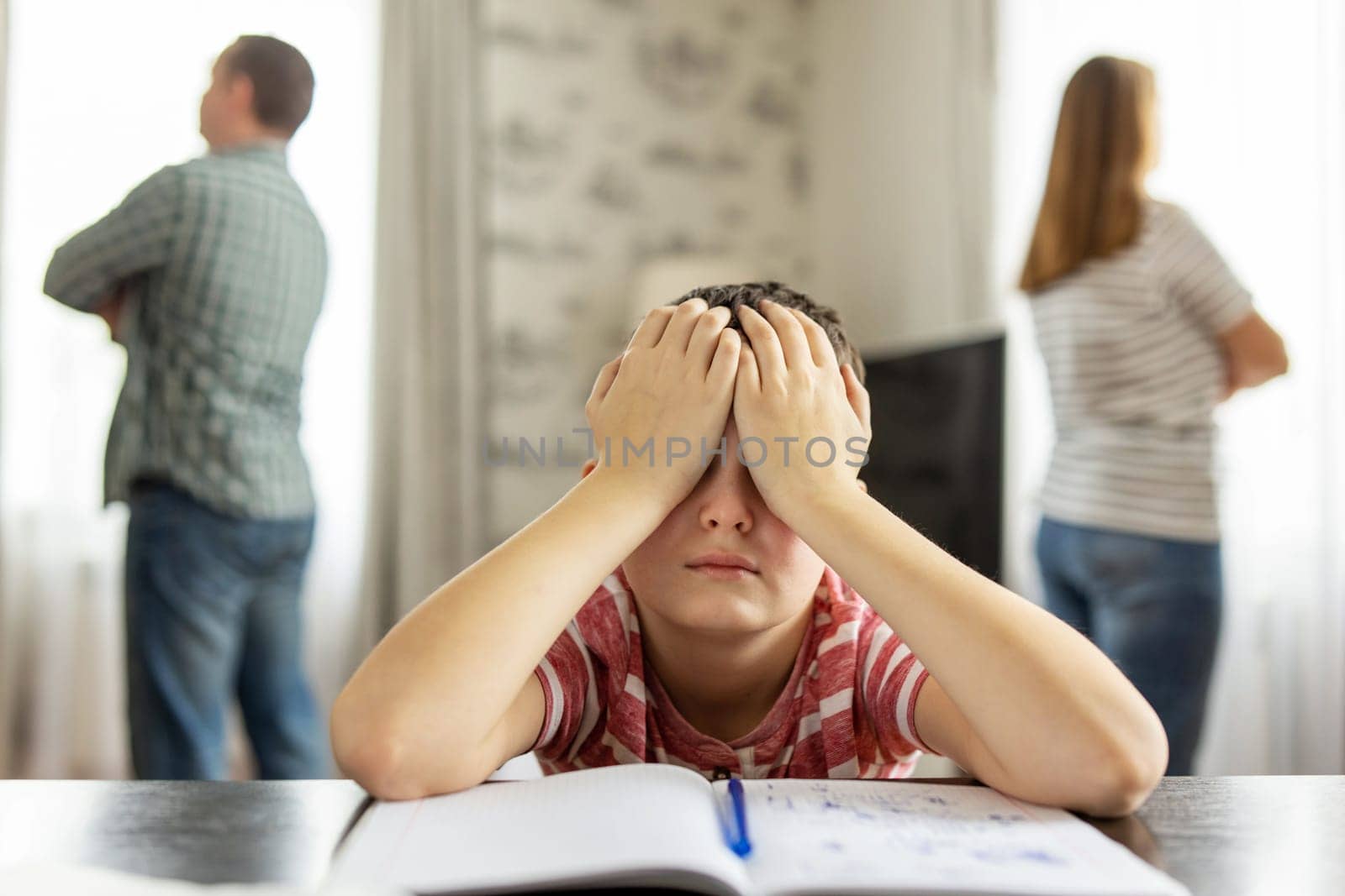 A quarrel between parents in the presence of an upset child covering his eyes with his hands. The concept of a family crisis, problems in the family and the need to solve them