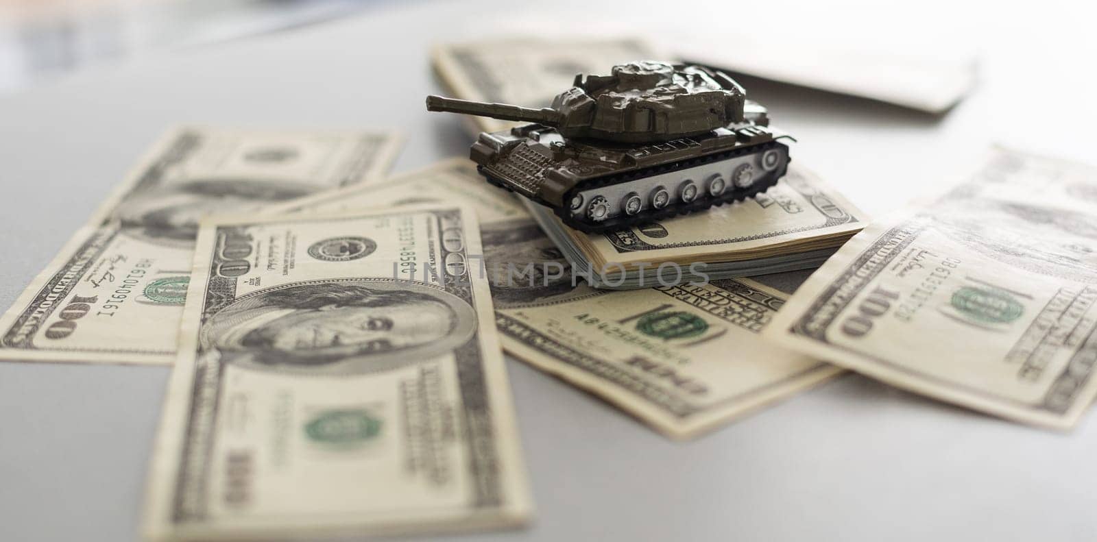 tank against the background of dollars. Concept of war. by Andelov13