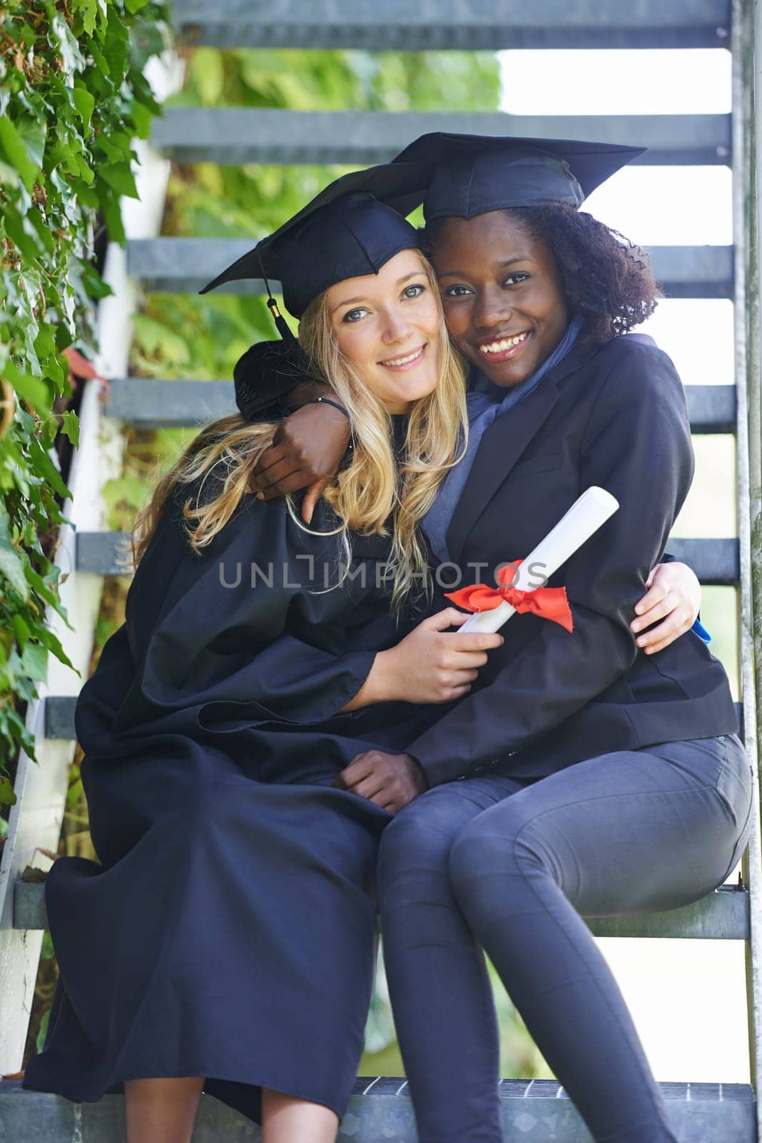 Graduation, college and women or friends hug for education achievement, success and celebration of diploma. Portrait of students in diversity with law certificate, university campus by stairs.
