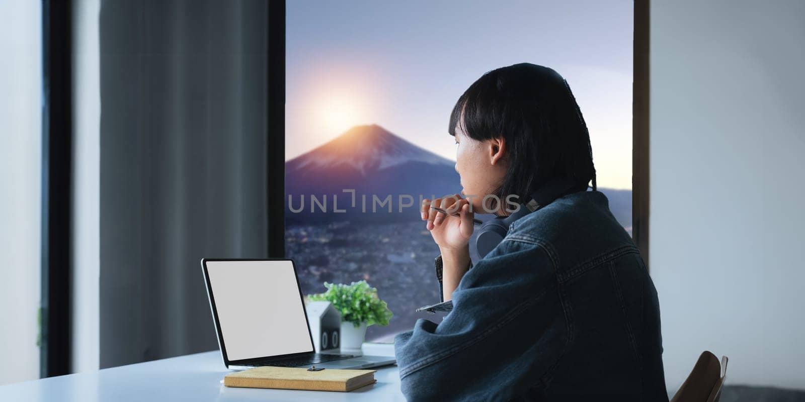 blank screen of man hand working on laptop computer and peper work while sitting at the table, mockup blank screen for product display or graphic design.